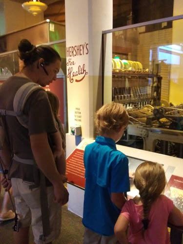Learning about an old chocolate machine at The Hershey Story Museum