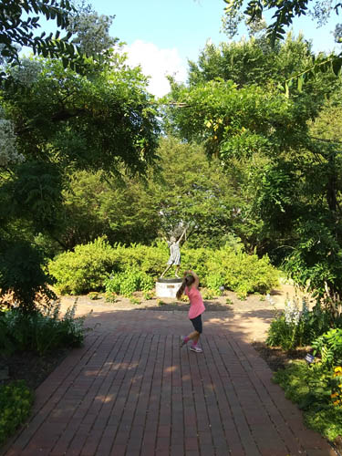 Girl chasing butterfly statue at The Hershey Gardens